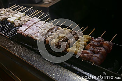 Grilled yakitori chicken skewers at an Izakaya restaurant in Omoide Yokocho street in the Shinjuku district of Tokyo.. Stock Photo