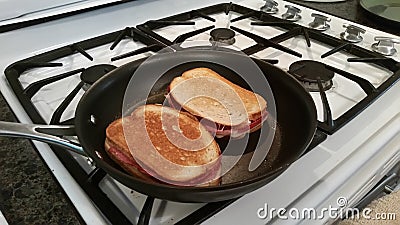 Grilling Cheese and Meat Sandwiches Stock Photo