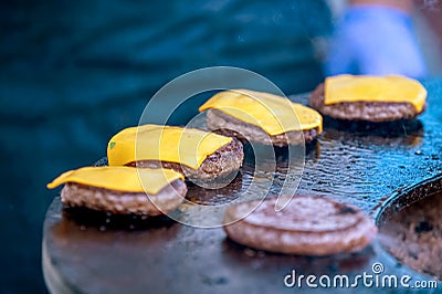 Grilling hamburger patties with cheese open air Stock Photo