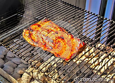 Grilling salmon fillet on a cedar-plank Stock Photo