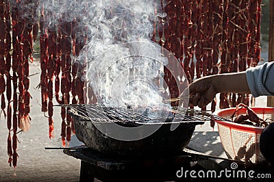 Grilling skewer sausage in mekong delta Stock Photo