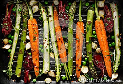 Grilling vegetables, raw vegetables prepared for grilling with the addition of olive oil, herbs and spices located on the grill pl Stock Photo