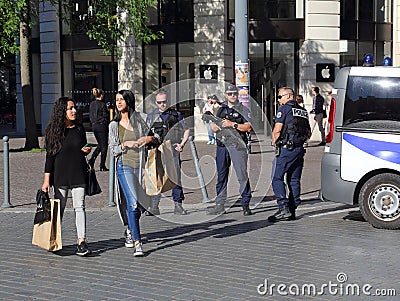 Grils shopping and policemen guarding the road Editorial Stock Photo