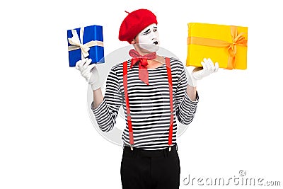 grimacing mime holding gift boxes Stock Photo