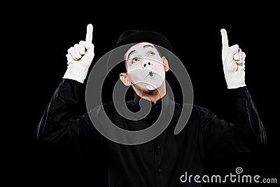 grimacing mime pointing on something Stock Photo