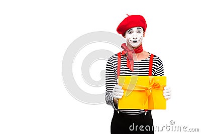 grimacing mime showing gift box Stock Photo
