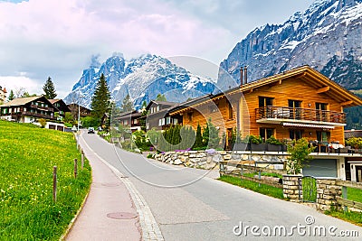 Grindelwald valley with village scattered on the green slopes o Stock Photo