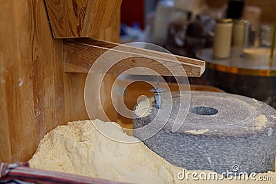 grinding grain into fresh flour at the local market Stock Photo