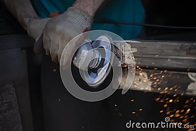 Grinding of metal. Sparks from power tools. The man works in the garage Stock Photo