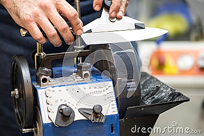 Grindstone close-up. Electric Knife Sharpening Machine Stock Photo