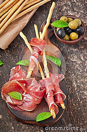 Grissini bread sticks with ham Stock Photo