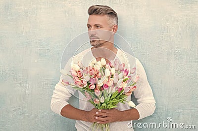 grizzle man with valentine flowers. man with valentine flowers in studio. Stock Photo