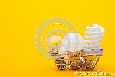 In the grocery basket are different types of light bulbs - incandescent, energy-saving and LED Stock Photo