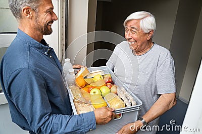 Grocery Food Shopping Help For Elder Senior Standing Stock Photo