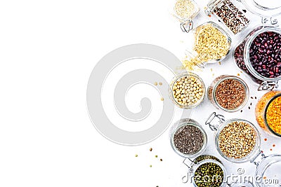 Grocery, home stocks in plastic free storage and jars. Various beans, grains, cereals, legumes, seeds in reusable cans. White Stock Photo