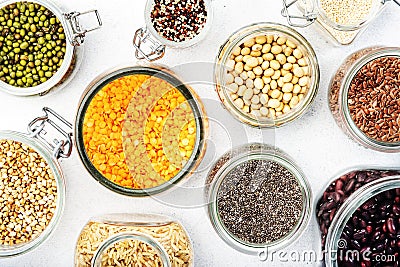 Grocery, home stocks in plastic free storage and jars. Various beans, grains, cereals, legumes, seeds in reusable cans. White Stock Photo