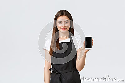 Grocery store employees, small business and coffee shops concept. Cute smiling saleswoman recommend download online Stock Photo