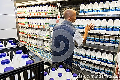 Grocery store staff packing shelves at Pick `n Pay grocery store during virus outbreak Editorial Stock Photo