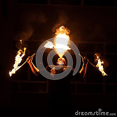Grodno, Belarus - April, 30, 2012 fire show, fire blowing performance, dancing with flame, male master fakir with fire works on st Editorial Stock Photo