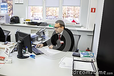 GRODNO, BELARUS - AUGUST 2017: employees to answer the call in the store at work at the computer in modern shop Editorial Stock Photo