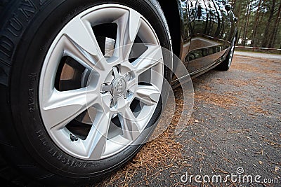 GRODNO, BELARUS - DECEMBER 2019: Audi A6 4G C7 Luxury car closeup alloy wheel with Dunlop winter tires side view with Editorial Stock Photo