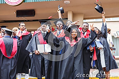 GRODNO, BELARUS - JUNE, 2018: Happy foreign african medical students in square academic graduation caps and black raincoats during Editorial Stock Photo