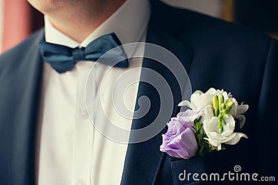 Groom in black suit with flower buttonhole Stock Photo