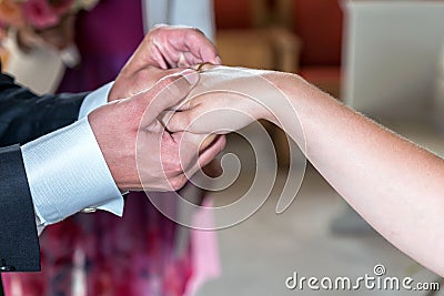 The groom and the bride exchange rings. Stock Photo