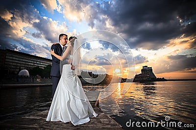 Groom, bride, sunset, beach Stock Photo