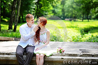 Groom fixes his blue bow tie standing before the bride on old st Stock Photo
