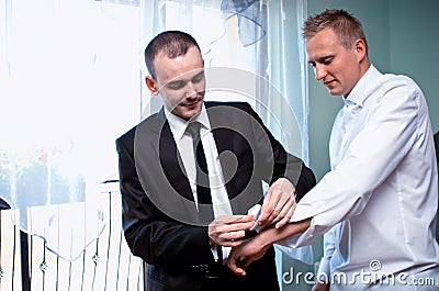 Groom getting dressed Stock Photo