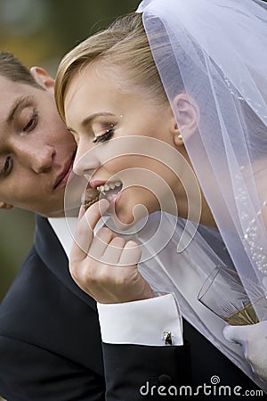 Groom giving bonbon to bride Stock Photo