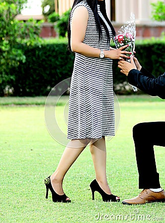 Groom giving bouquet to his bride Stock Photo