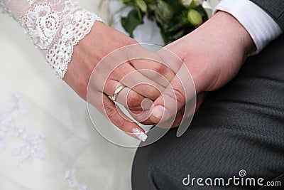 Groom holds the bride by the hand closeup Stock Photo