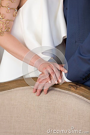 Groom holds the bride's hand Stock Photo