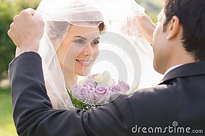 Groom Looking At Bride With Love Stock Photo