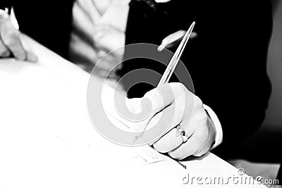 Groom signing wedding contract Stock Photo