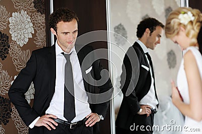 Groom watching his bride getting ready Stock Photo