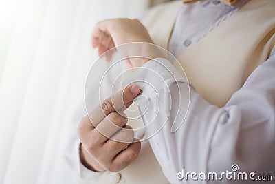 Groom wear cufflink in wedding ceremony Stock Photo