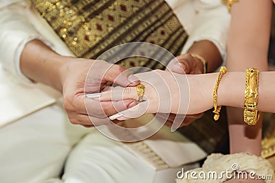 Groom wearing wedding ring for his bride hand Stock Photo