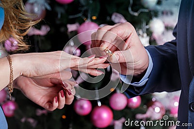 The groom wears the ring to bride`s finger at wedding day. Love, happy marry concept. Stock Photo
