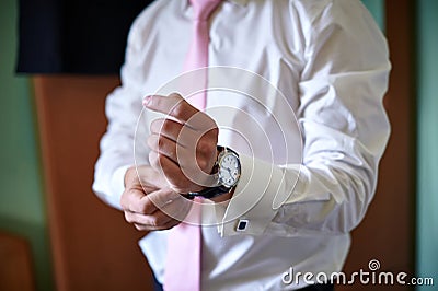 Groom wears a watch on the hand Stock Photo