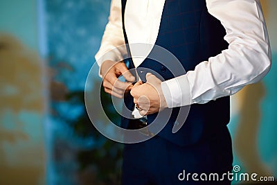 Grooms morning preparation, handsome groom getting dressed and preparing for the wedding, the jacket is laid Stock Photo