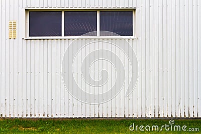 Grooved metal wall with a window Stock Photo