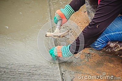Grooving on concrete pavement by worker used deformed steel bar Stock Photo