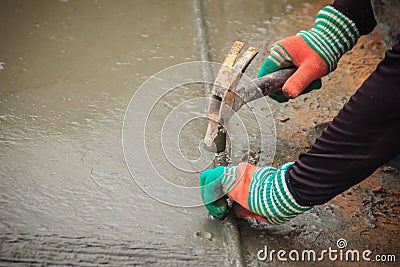 Grooving on concrete pavement by worker used deformed steel bar Stock Photo