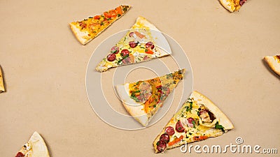Grop of triangular slices of different types of pizza on a beige kraft paper background Stock Photo
