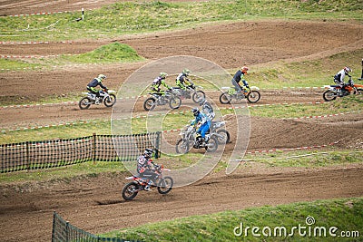 Gross Schwiesow, Germany - March 01,2019 - Motocross racers jump over a sand hill. Editorial Stock Photo