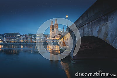 Grossmunster Church and Munsterbrucke Bridge at night - Zurich, Switzerland Stock Photo