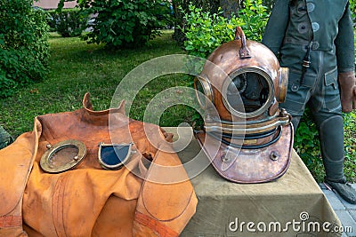 A grotesque diving suit for deep-sea exploration and adventure. Antique diving suit made of metal and leather at the exhibition of Editorial Stock Photo